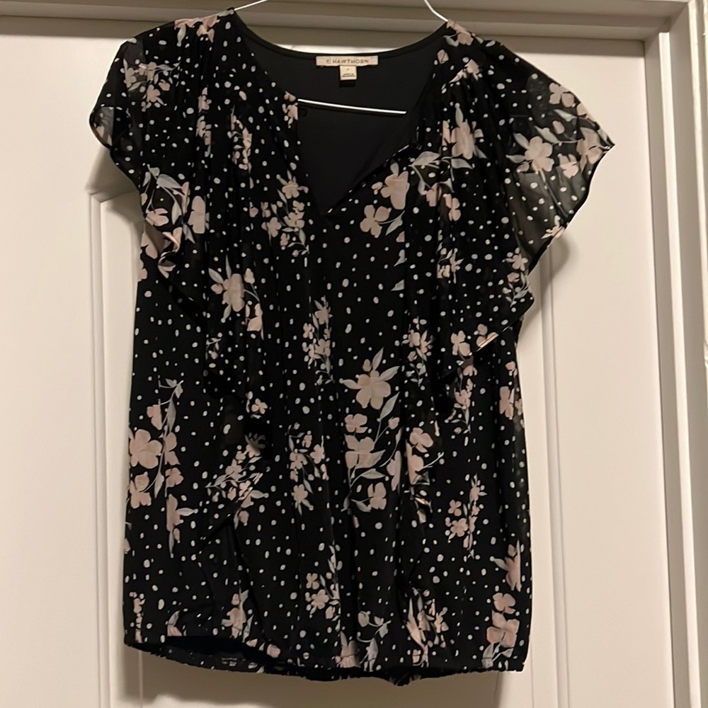 Super cute dressy top with ruffle detail down the front.